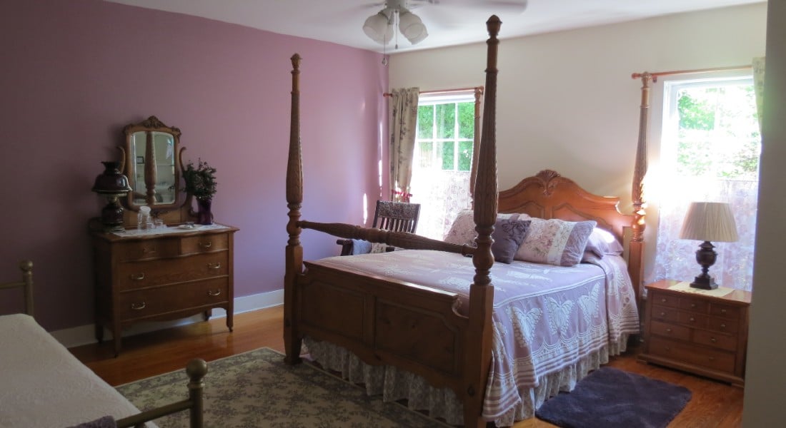 Large room with dresser and four poster bed