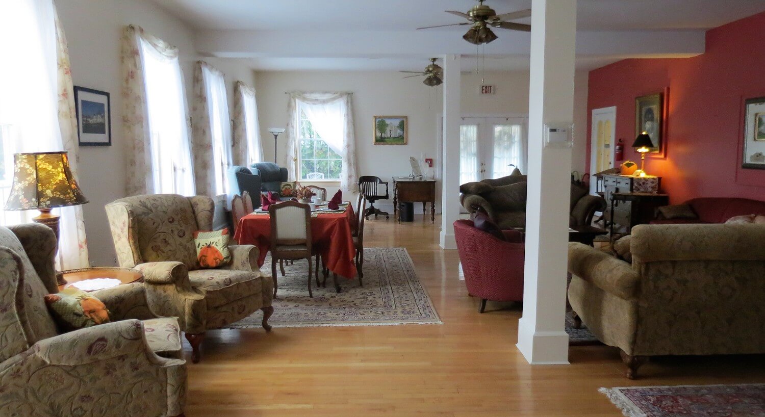 Sitting area in B&B with several upholstered chairs and sofas. 